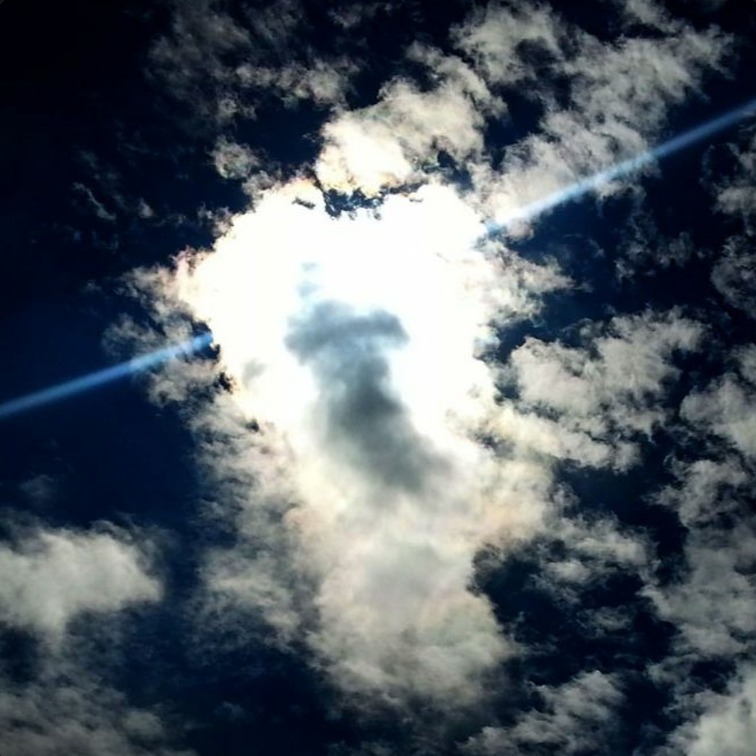 Sun breaking through dark clouds
